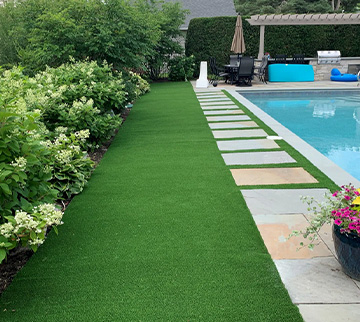 Chicago home with Pool surround featuring synthetic grass around it
