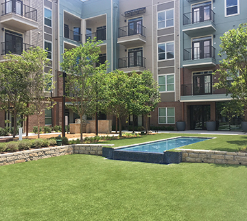 Synthetic grass lawn installed outside Texas apartment complex