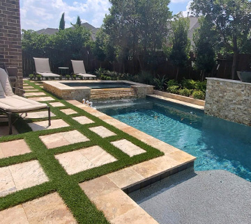 Dallas home with Pool surround featuring synthetic grass around it