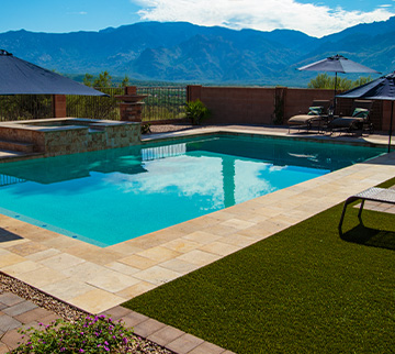 Arizona home with Pool surround featuring synthetic grass around it