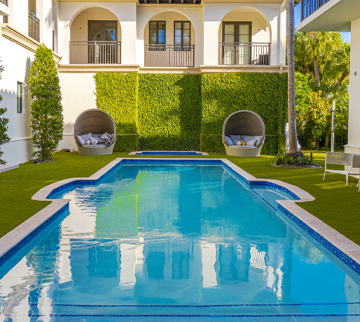 Pool surround featuring synthetic grass around it