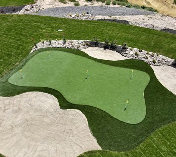 Outdoor artificial grass putting green in the backyard of a home