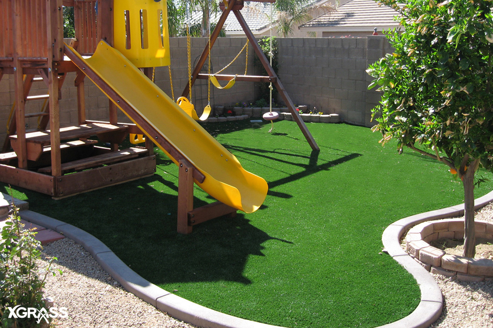 Backyard playground with synthetic grass surfacing