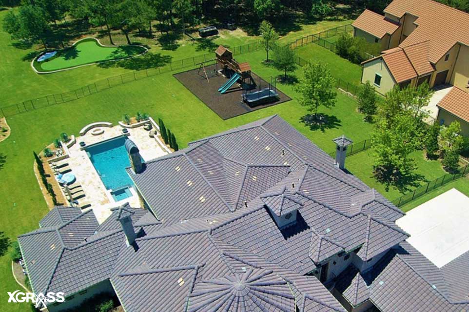 Large backyard space with a playground, backyard putting greens, and a swimming pool