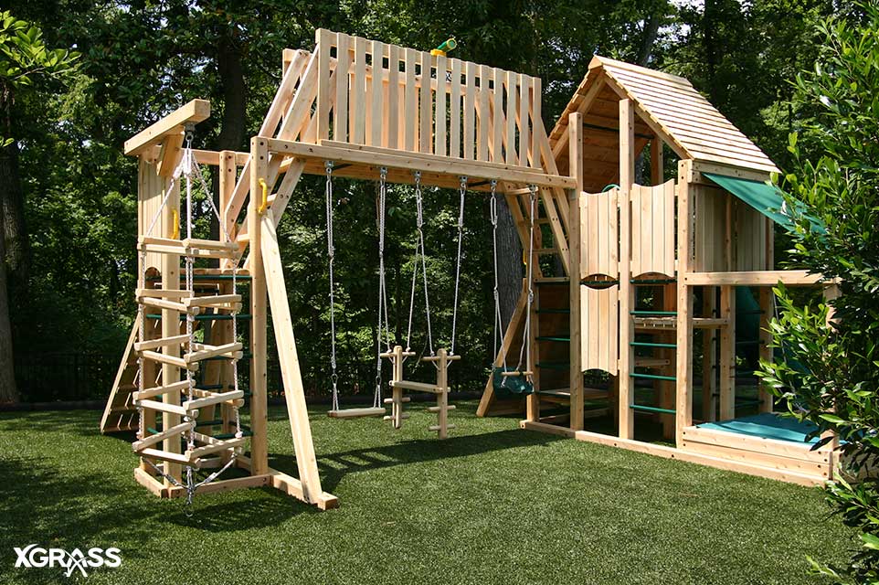 Backyard playground with artificial grass flooring