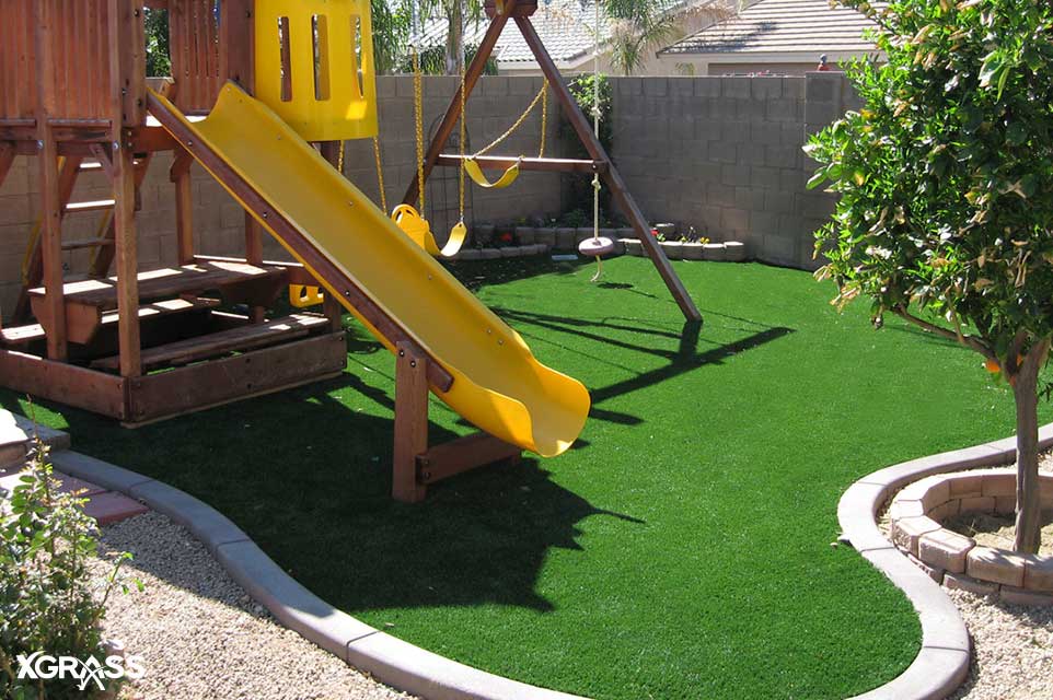 Synthetic grass installed underneath this small playground set