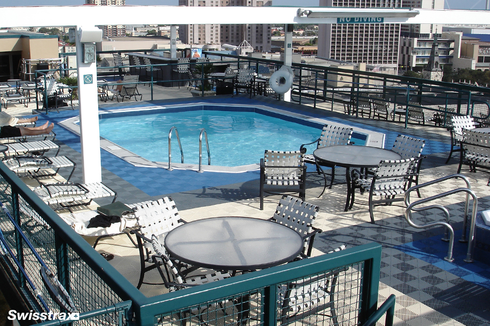 Swisstrax modular flooring installed around a swimming pool