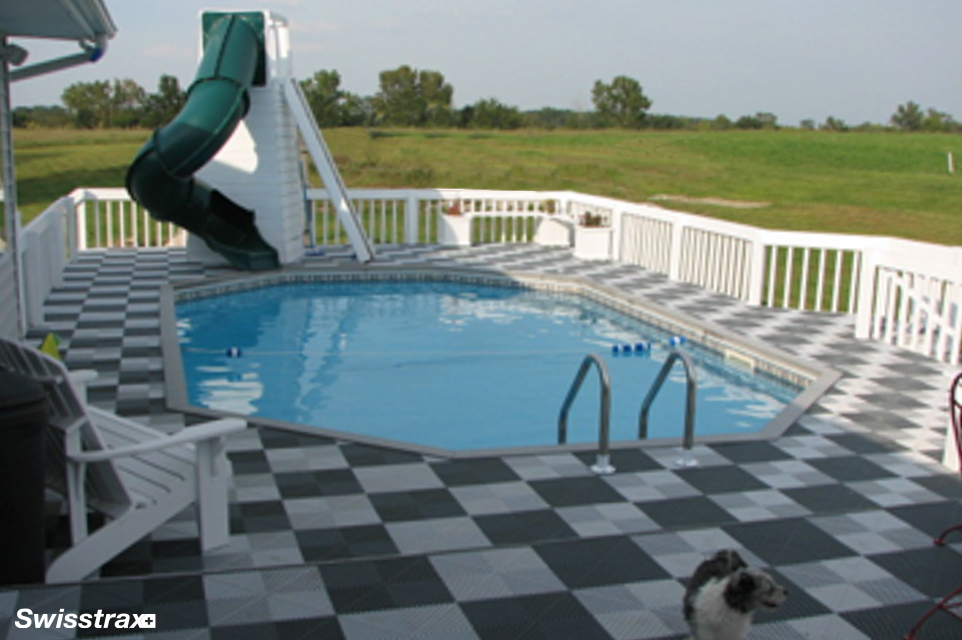 Backyard swimming pool with Swisstrax modular flooring installed around it