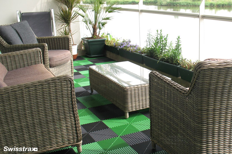 Green and black swisstrax tiles installed on a backyard patio