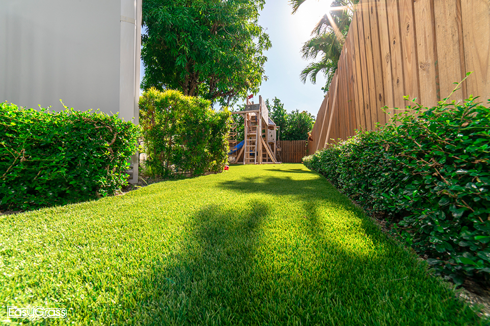 Beautiful artificial grass lawn in the side yard