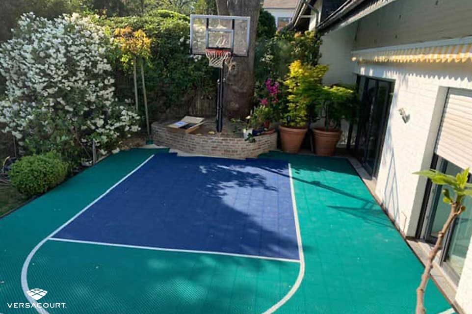 Side yard with a small basketball court