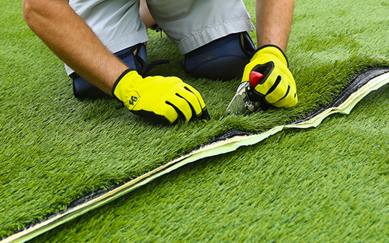 Lanmark Installation employee installing turf