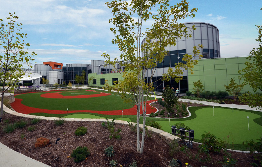 Artificial grass baseball field and putting green outside commercial facility
