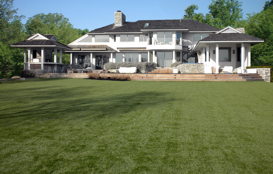 Artificial grass lawn installed next to a large residence
