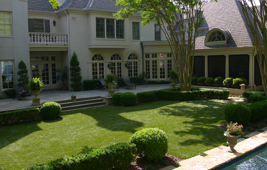Artificial grass lawn in residential backyard