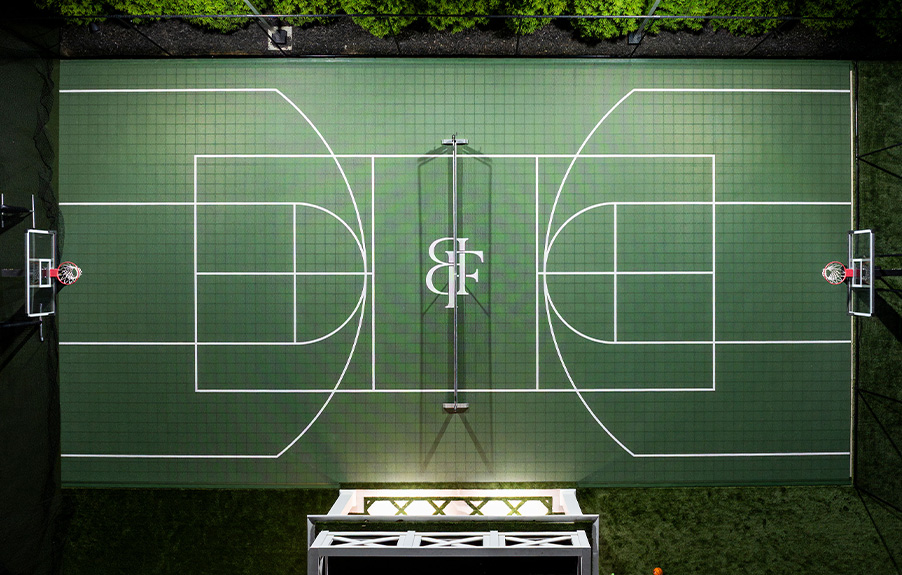 Aerial view of green multi-sport game court with white game lines